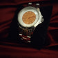 Montre femme de seconde main orange et silver .